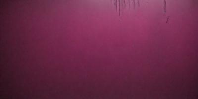 The primary subject of the image is a large, pink surface. The setting appears to be a dark room, with the pink surface being the main focus. The visual style of the image is a close-up of the pink surface, which gives it a unique and striking appearance. The colors and mood of the image are predominantly pink, creating a warm and vibrant atmosphere.
