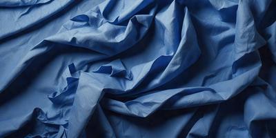 The primary subject of the image is a blue sheet of fabric, which is the main object, scene, or focus of the image. The setting or background is a blue cloth, and the visual style is a photo. The dominant colors and overall atmosphere are blue and calm.