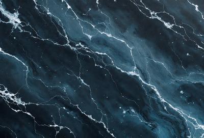 The primary subject of the image is a close-up of a marble surface with a blue and white color scheme. The setting is a dark room, and the visual style appears to be a photo. The dominant colors are blue and white, creating a calm and serene atmosphere.
