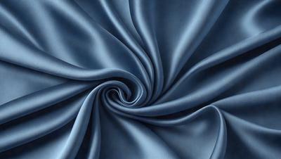 The primary subject of the image is a blue fabric, which appears to be a piece of cloth or a curtain. The setting is a room with a blue background, which complements the blue fabric. The visual style is a close-up of the fabric, showcasing its texture and details. The colors and mood of the image are predominantly blue, creating a calm and serene atmosphere.