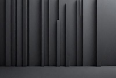 The primary subject of the image is a black and white photo of a wall with a pattern of vertical lines. The setting is a black background, and the visual style is a close-up of the wall. The dominant colors are black and white, creating a stark and minimalist atmosphere.