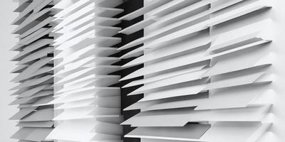 The primary subject of the image is a large white wall with a row of vertical blinds. The setting is a room with a black background, which contrasts with the white blinds. The visual style is a black and white photograph, giving the image a classic and timeless appearance. The dominant colors are white and black, creating a clean and minimalist atmosphere.