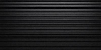 The primary subject of the image is a black and white photo of a wall. The setting is a black background, and the visual style is a black and white photograph. The colors and mood of the image are predominantly black, creating a stark and dramatic atmosphere.