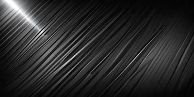 The primary subject of the image is a pattern of black and white stripes. The setting is a dark background, which contrasts with the pattern. The visual style is a black and white photo, giving it a classic and timeless appearance. The colors and mood of the image are predominantly dark and moody, with the black and white stripes creating a sense of depth and contrast.