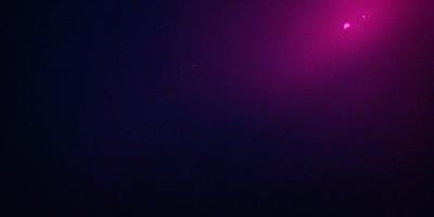 The primary subject of the image is a purple sky with a few stars visible. The setting is a dark, starry night with a pinkish hue. The visual style is a nighttime scene with a celestial focus. The colors and mood are predominantly purple and pink, creating a serene and peaceful atmosphere.