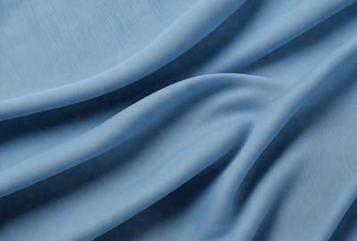 The primary subject of the image is a blue fabric, which appears to be a piece of cloth or a curtain. The setting is a room with a blue background, which creates a cohesive and visually appealing environment. The visual style of the image is a close-up of the blue fabric, showcasing its texture and details. The colors and mood of the image are predominantly blue, giving it a calm and serene atmosphere.