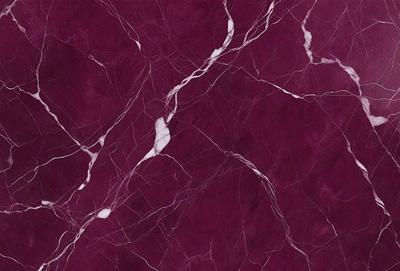 The primary subject of the image is a marble wall with a purple hue. The setting is a room with a purple background. The visual style is a close-up of the marble wall, showcasing its texture and pattern. The colors and mood of the image are predominantly purple, creating a calm and elegant atmosphere.