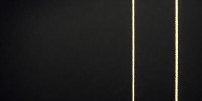 The primary subject of the image is a black background with a yellow line running through it. The setting is a dark room, and the visual style appears to be a combination of a photo and a digital art or illustration. The colors and mood of the image are predominantly dark, with the yellow line adding a touch of brightness and contrast.