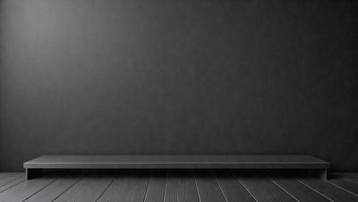 The primary subject of the image is a large, empty room with a gray wall. The setting is a dark room with a wooden floor. The visual style is a photo, and the colors and mood are dark and moody.