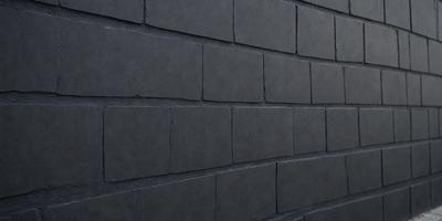 The primary subject of the image is a brick wall. The setting is a dark room, and the visual style is a photo. The dominant colors are gray, and the overall atmosphere is moody and somewhat mysterious.