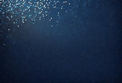 The primary subject of the image is a blue background with a pattern of white dots. The setting appears to be a dark, starry night, with the blue background providing a contrasting backdrop. The visual style of the image is a combination of a photo and digital art, creating a unique and captivating atmosphere. The dominant colors are blue and white, with the white dots adding a touch of brightness to the overall mood of the scene.