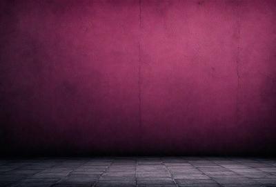 The primary subject of the image is a pink wall. The setting is a room with a pink wall, and the visual style is a photo. The dominant colors are pink, and the overall atmosphere is warm and inviting.