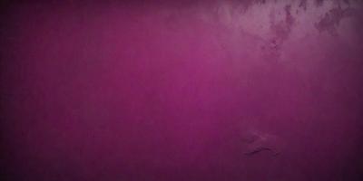 The primary subject of the image is a large, purple wall. The setting is a room with a purple background, which creates a unique and striking visual effect. The visual style of the image is a close-up of the purple wall, emphasizing its vibrant color. The dominant colors in the image are purple and pink, giving the scene a warm and inviting atmosphere.