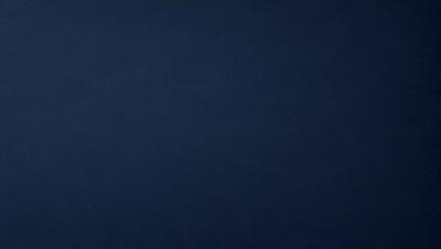 The primary subject of the image is a dark blue sky. The setting is a vast, open space with no visible landmarks or objects. The visual style is a simple, monochromatic image with no additional elements or textures. The colors and mood convey a sense of calmness and tranquility.