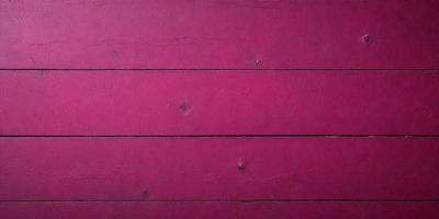 The primary subject of the image is a pink wooden wall. The setting is a room with a pink wall, and the visual style is a close-up of the wall. The dominant colors are pink, and the overall atmosphere is warm and inviting.