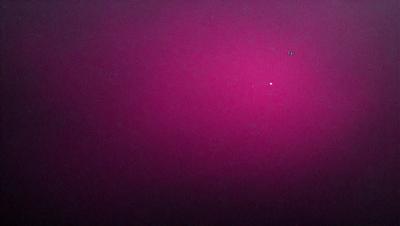 The primary subject of the image is a pink background with a purple hue. The setting is a dark, possibly black, background. The visual style appears to be a digital art or illustration, as the colors and mood are vibrant and bold.