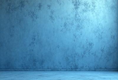 The primary subject of the image is a blue wall with a pattern of white dots. The setting is a room with a blue floor, and the visual style appears to be a photo. The dominant colors are blue and white, creating a calm and serene atmosphere.