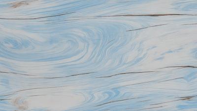 The primary subject of the image is a wooden surface with a blue and white pattern. The setting is a wooden table, and the visual style is a close-up of the table's surface. The colors and mood of the image are predominantly blue and white, creating a calm and serene atmosphere.