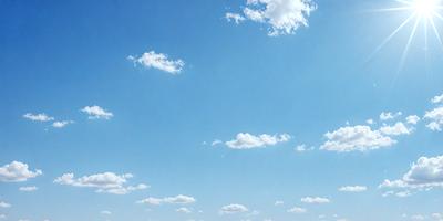 The primary subject of the image is the sky, which is filled with clouds. The setting is a clear blue sky, and the visual style is a photo. The clouds are scattered throughout the sky, creating a dynamic and lively atmosphere. The colors are predominantly blue and white, with the clouds adding a touch of gray.