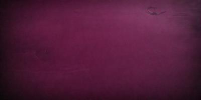The primary subject of the image is a purple surface, which appears to be a wall or a piece of fabric. The setting is a room with a purple background, and the visual style is a close-up of the purple surface. The colors and mood of the image are predominantly purple, creating a calm and serene atmosphere.
