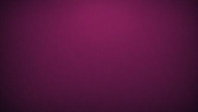 The primary subject of the image is a purple background. The setting is a dark, purple room with a pinkish hue. The visual style is a close-up of the purple background, which creates a moody and dramatic atmosphere.