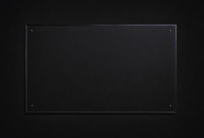The primary subject of the image is a black leather-like surface. The setting is a dark room, and the visual style appears to be a photo. The colors and mood of the image are predominantly dark and moody, with the black leather-like surface being the main focus.