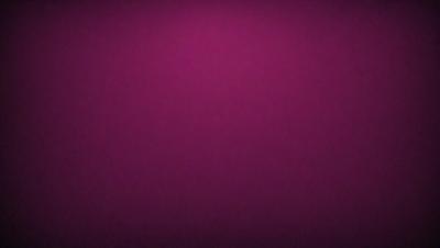The primary subject of the image is a purple background. The setting is a dark room, and the visual style appears to be a photo. The dominant colors are purple and black, creating a moody atmosphere.