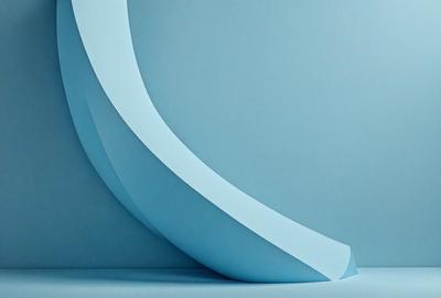 The primary subject of the image is a blue wall with a white, curved, and circular shape on it. The setting is a room with a blue background, and the visual style appears to be a photo. The colors and mood of the image are predominantly blue, creating a calm and serene atmosphere.