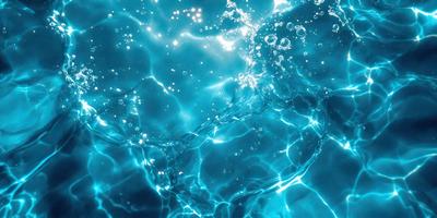 The primary subject of the image is a close-up of a body of water, possibly a swimming pool or a lake. The water appears to be blue and has a few bubbles floating on the surface. The setting is a clear, blue sky, which provides a beautiful backdrop for the water. The visual style of the image is a close-up, which emphasizes the details of the water and its surroundings. The colors and mood of the image are serene and calming, with the blue water and the