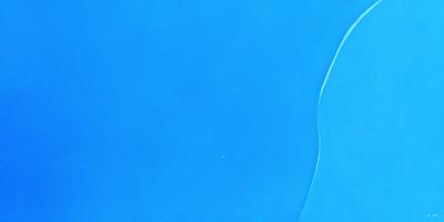 The primary subject of the image is a blue surface, which appears to be a piece of blue paper or a blue background. The setting is a clear blue sky, which creates a serene and peaceful atmosphere. The visual style of the image is a close-up of the blue surface, showcasing its vibrant color and texture. The colors and mood of the image are predominantly blue, conveying a sense of calmness and tranquility.