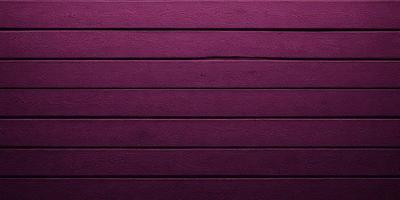 The primary subject of the image is a purple wall with a wooden texture. The setting is a room with a purple wall, and the visual style is a close-up of the wall. The dominant colors are purple and brown, creating a calm and soothing atmosphere.