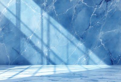 The primary subject of the image is a marble wall with a blue tint. The setting is a room with a blue wall, and the visual style is a photo. The dominant colors are blue and white, creating a calm and serene atmosphere.