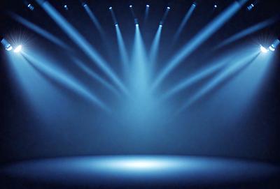 The primary subject of the image is a stage with a blue background. The stage is illuminated by a series of bright lights, creating a dramatic and captivating atmosphere. The visual style of the image is a photo, capturing the lighting and stage design in detail. The colors and mood of the image are predominantly blue, creating a sense of depth and sophistication.