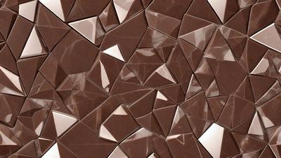 The primary subject of the image is a close-up of a brown marble tile with a pattern of triangles. The setting is a wall, and the visual style is a close-up of the tile. The colors and mood of the image are warm and earthy, with the brown marble tile being the dominant color.