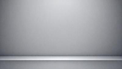 The primary subject of the image is a large, empty white wall. The setting is a room with a gray background. The visual style is a photo, and the colors and mood are predominantly white and neutral.