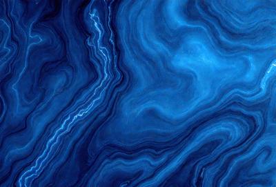 The primary subject of the image is a blue and white marbled stone. The setting is a dark blue background, which contrasts with the light blue and white marbled stone. The visual style is a close-up of the marbled stone, showcasing its unique texture and pattern. The colors and mood of the image are predominantly dark and moody, with the blue and white marbled stone serving as the focal point.