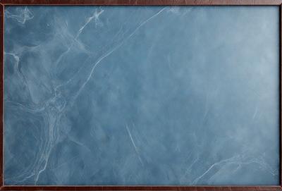 The primary subject of the image is a blue marble tabletop. The setting is a room with a wooden frame surrounding the table. The visual style is a close-up of the marble tabletop, showcasing its texture and color. The colors and mood of the image are predominantly blue, creating a calm and serene atmosphere.