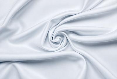 The primary subject of the image is a white sheet of fabric, which is the main object, scene, or focus of the image. The setting or background is a white sheet of fabric, and the visual style is a photo. The colors and mood of the image are predominantly white, giving it a clean and simple appearance.