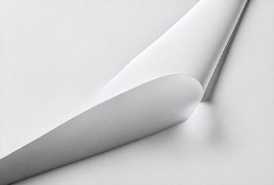 The primary subject of the image is a white sheet of paper. The setting is a white background, which creates a clean and minimalist appearance. The visual style is a close-up of the paper, emphasizing its texture and details. The colors and mood are predominantly white, giving the image a calm and serene atmosphere.