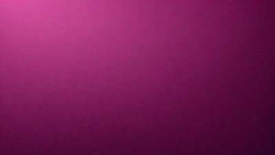 The primary subject of the image is a large, pink wall. The setting is a room with a purple background. The visual style is a close-up of the wall, which gives a sense of depth and texture. The colors and mood of the image are predominantly purple, creating a calm and serene atmosphere.