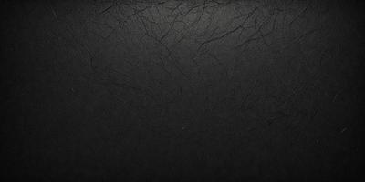 The primary subject of the image is a black leather surface. The setting is a black background, which creates a contrast with the leather. The visual style is a close-up of the leather, showcasing its texture and details. The colors and mood of the image are predominantly dark, with the black leather and background creating a moody atmosphere.