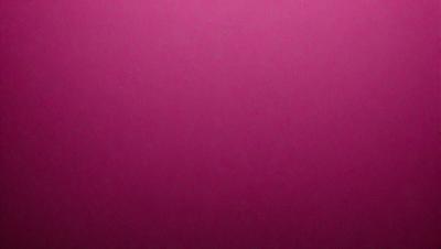 The primary subject of the image is a large, pink wall. The setting is a room with a pink background, and the visual style is a close-up of the wall. The dominant colors in the image are pink, and the overall atmosphere is warm and inviting.