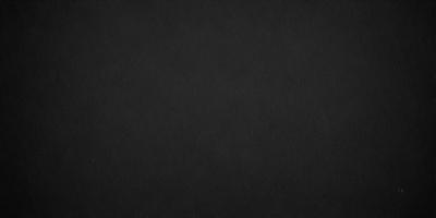 The primary subject of the image is a black background. The setting is a dark, empty space, with no visible objects or elements. The visual style is a black and white photo, which gives the image a classic and timeless appearance. The colors and mood are predominantly dark and moody, creating a sense of mystery and depth.
