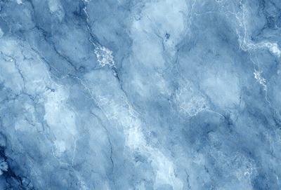 The primary subject of the image is a blue and white marbled wallpaper. The setting is a blue and white marbled wall, which serves as the background. The visual style is a digital art, as the image is a digital painting. The dominant colors are blue and white, creating a calm and serene atmosphere.