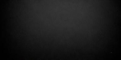The primary subject of the image is a black background. The setting is a dark, empty space, with no visible objects or elements. The visual style is a black and white photo, which gives the image a classic and timeless appearance. The colors and mood are predominantly dark and moody, creating a sense of mystery and depth.
