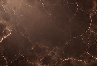 The image features a dark, textured surface with a pattern of light and dark areas. The primary subject is a close-up of the surface, which appears to be a marble or stone wall. The setting is indoors, with the wall being the main focus of the image. The visual style is a close-up of the surface, showcasing the intricate pattern and texture. The colors and mood of the image are predominantly dark, with the light and dark areas creating a moody atmosphere.
