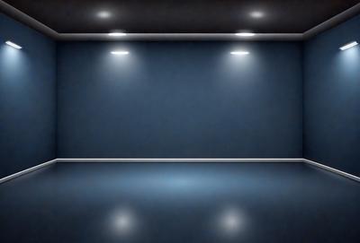 The primary subject of the image is a blue wall with a light shining on it. The setting is a dark room, and the visual style is a photo. The dominant colors are blue and black, creating a moody atmosphere.