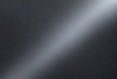 The primary subject of the image is a bright light shining through a dark background. The light appears to be a ray of light, and it is the main focus of the image. The setting is a dark room, and the visual style is a photo. The colors in the image are predominantly dark, with the bright light being the main source of color. The overall atmosphere of the image is one of contrast, with the bright light illuminating the dark background.