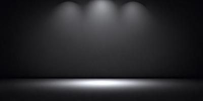 The primary subject of the image is a black background with a light source shining on it. The setting is a dark room, and the visual style is a black and white photo. The colors and mood of the image are predominantly dark and moody, with the light source creating a dramatic effect on the black background.