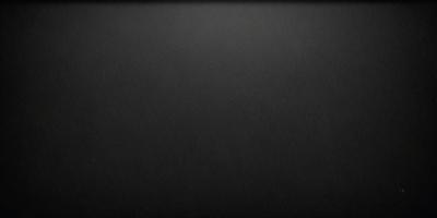 The primary subject of the image is a black background. The setting is a dark room, and the visual style is a black and white photo. The colors and mood are dark and moody, creating a sense of mystery or drama.